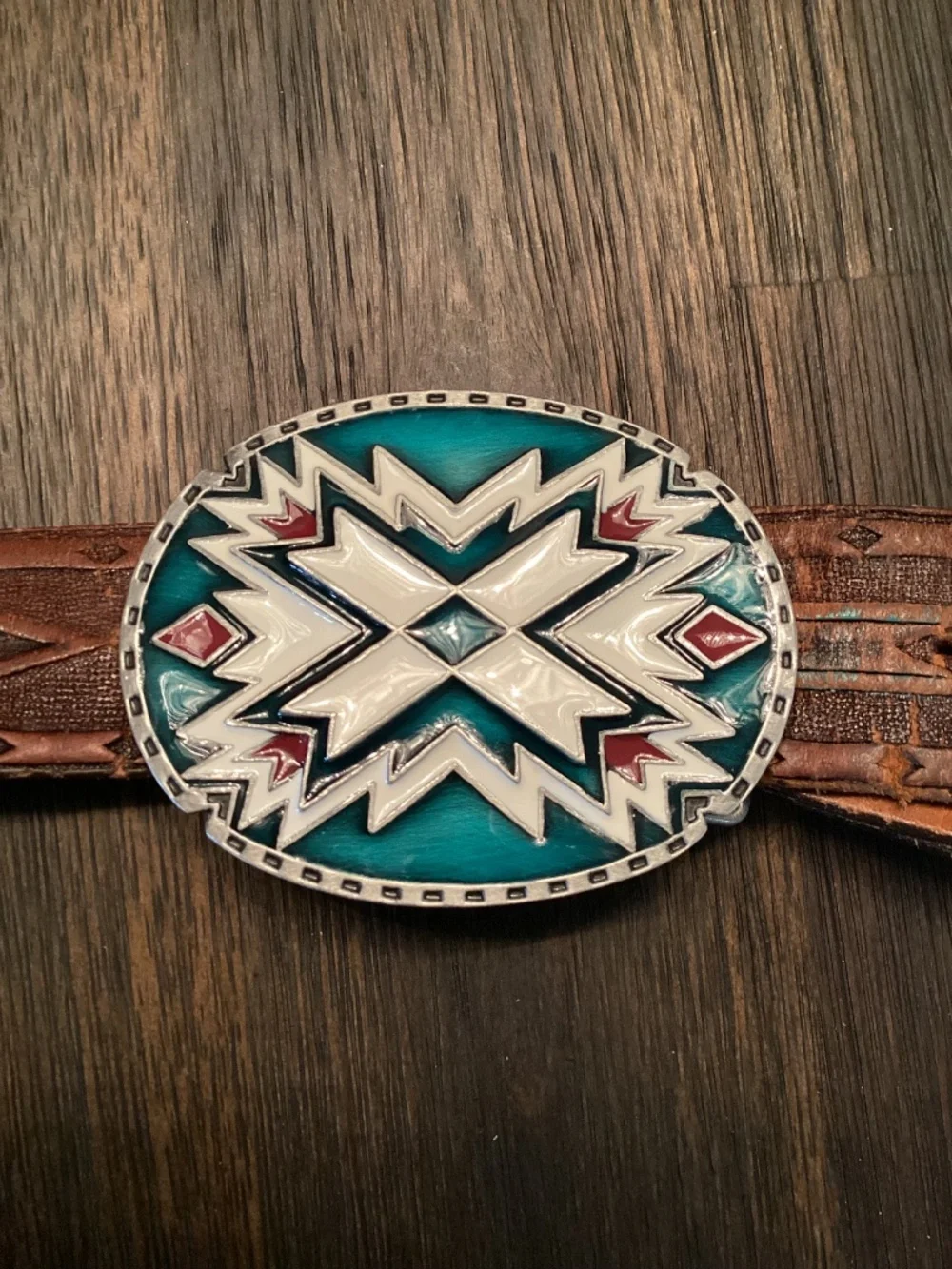 Vintage Siskiyou Buckle Co. enameled belt buckle paired with tooled leather belt